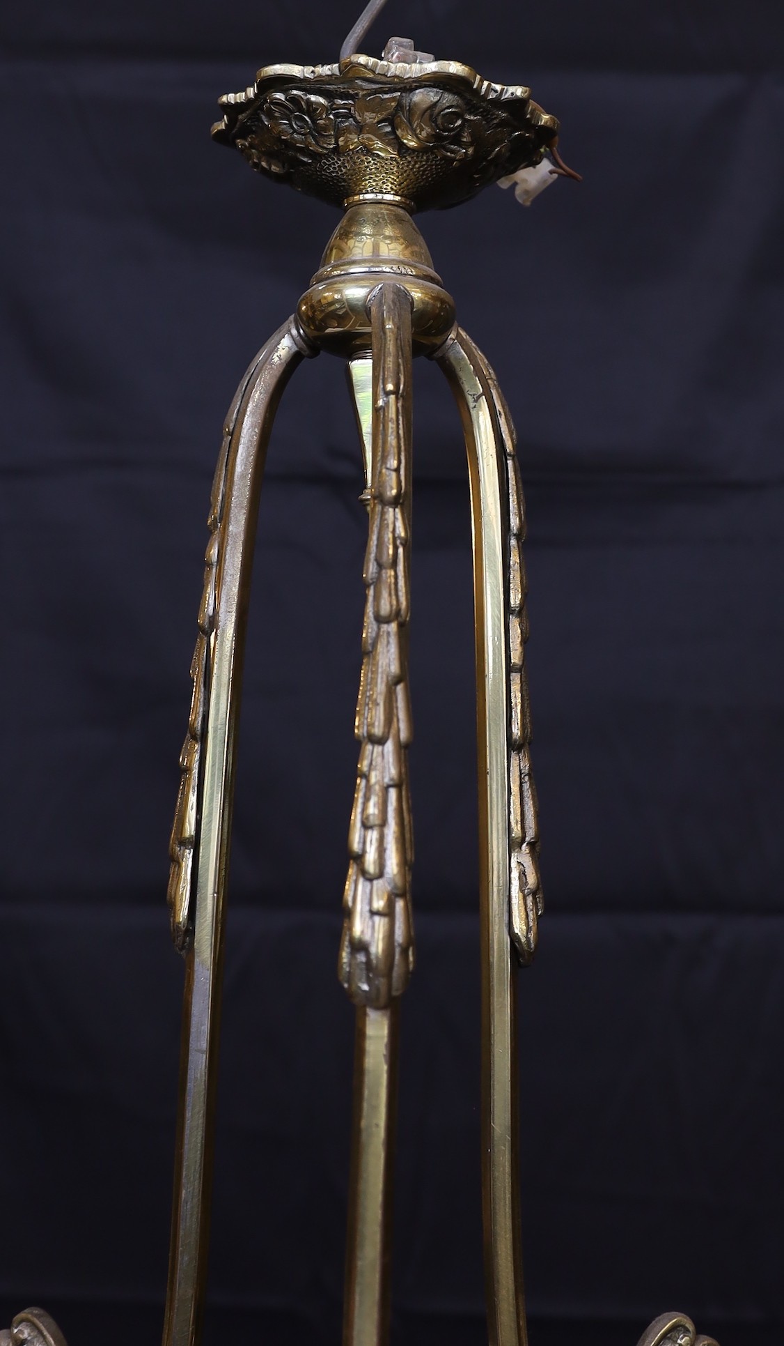A 1930s French brass three light chandelier with cranberry tinted frosted glass shades, height 70cm. width 60cm